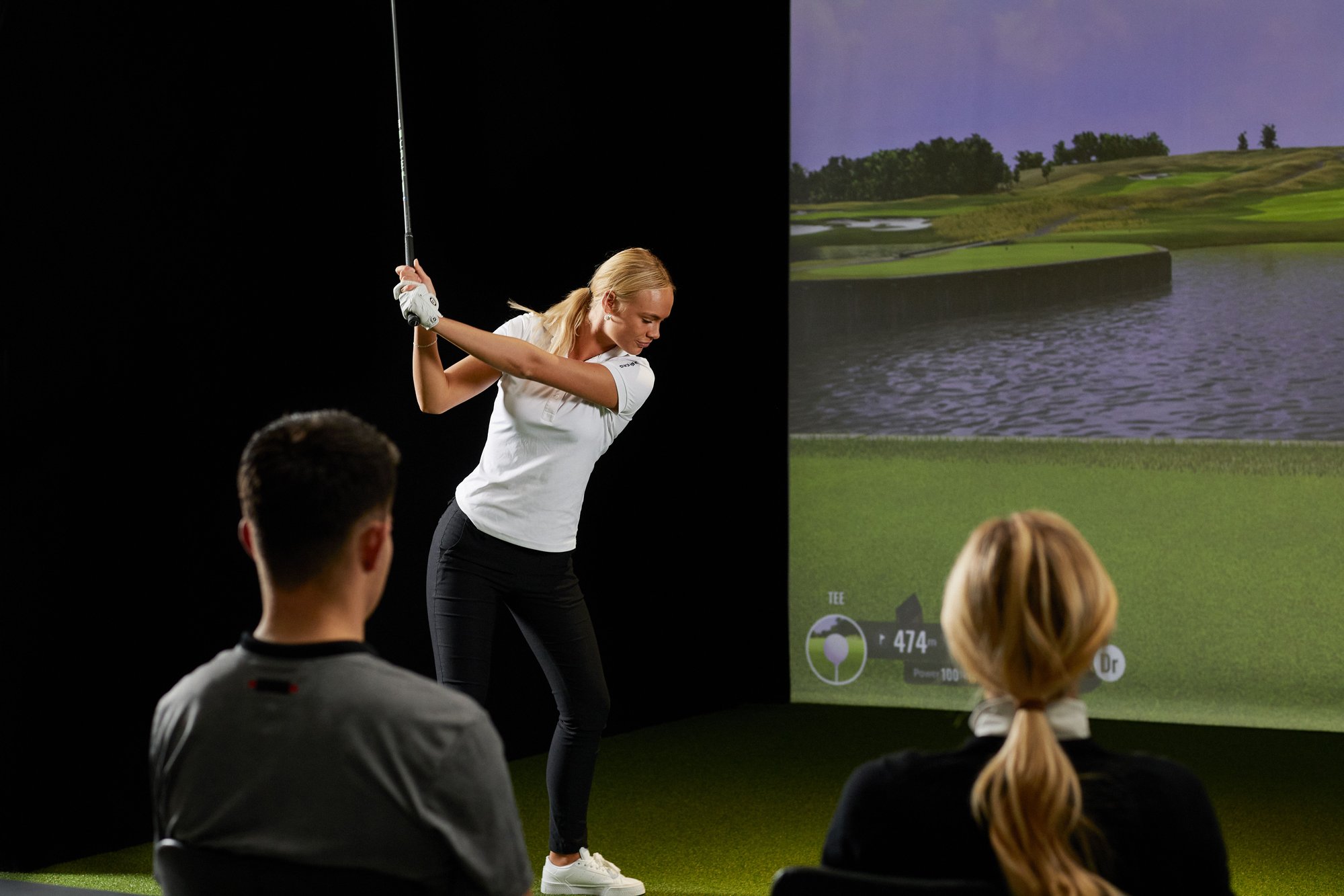 Friends playing a round of golf on a Trackman Golf simulator
